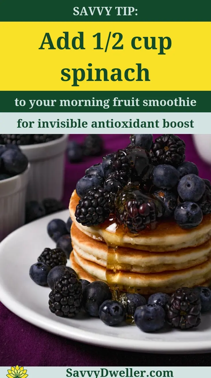 Healthy pancakes topped with berries and spinach for a boost of antioxidants.