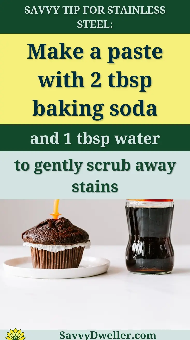 Chocolate cupcake decorated with burning candle and placed on white table with bottle of sweet coke