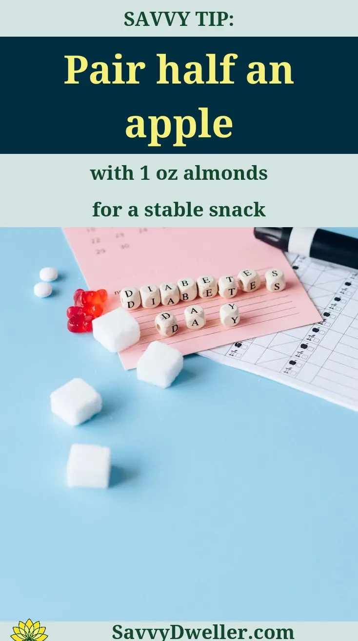 Healthy snack suggestion of half an apple paired with almonds to stabilize blood sugar for diabetics.