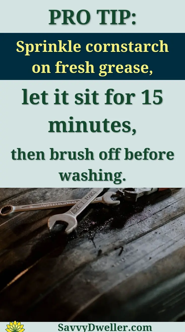 Barefoot individual hanging laundry on a drying rack inside an apartment.