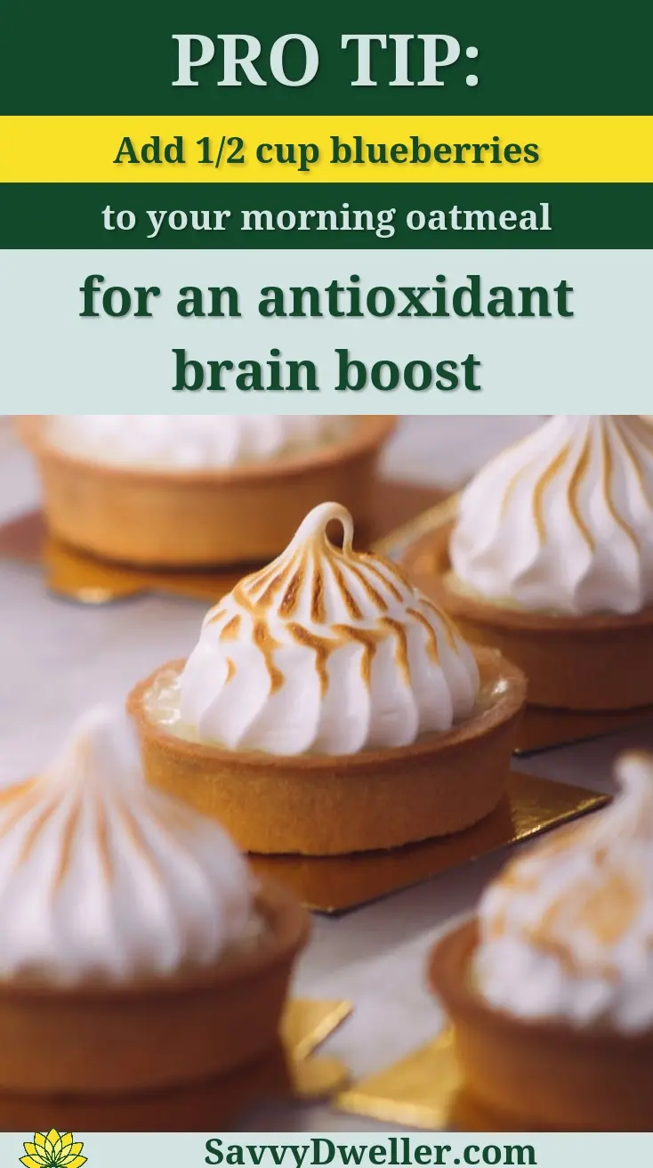Mouthwatering lemon meringue tarts with golden peaks on a baking tray.