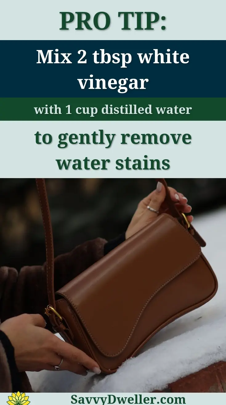 A leather purse being cleaned with a vinegar solution to remove water stains.