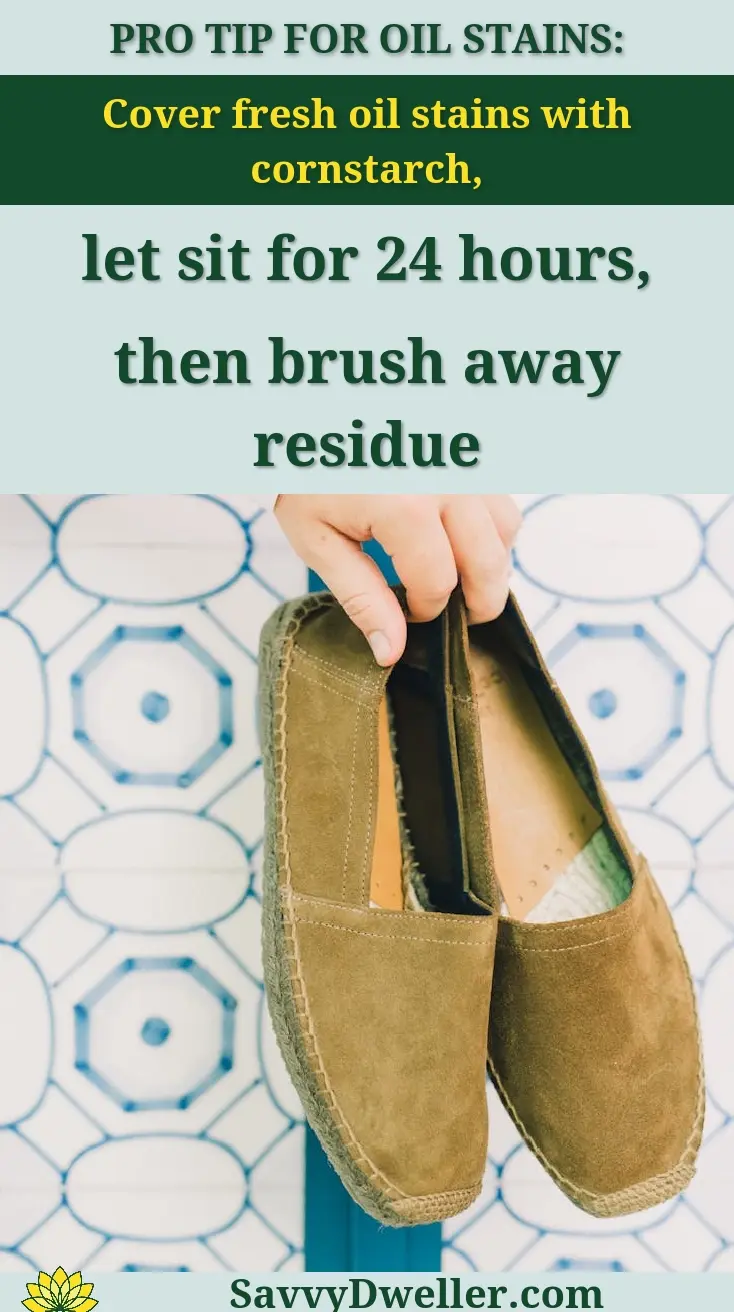 A person holding a pair of suede shoes, showcasing cleaning tips for suede jackets and shoes.