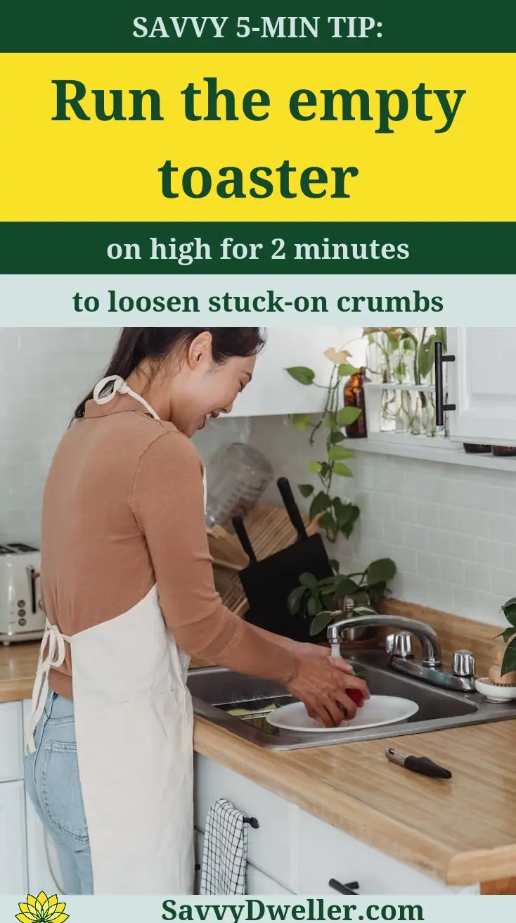 Person cleaning the crumb tray of a toaster to remove stuck crumbs.