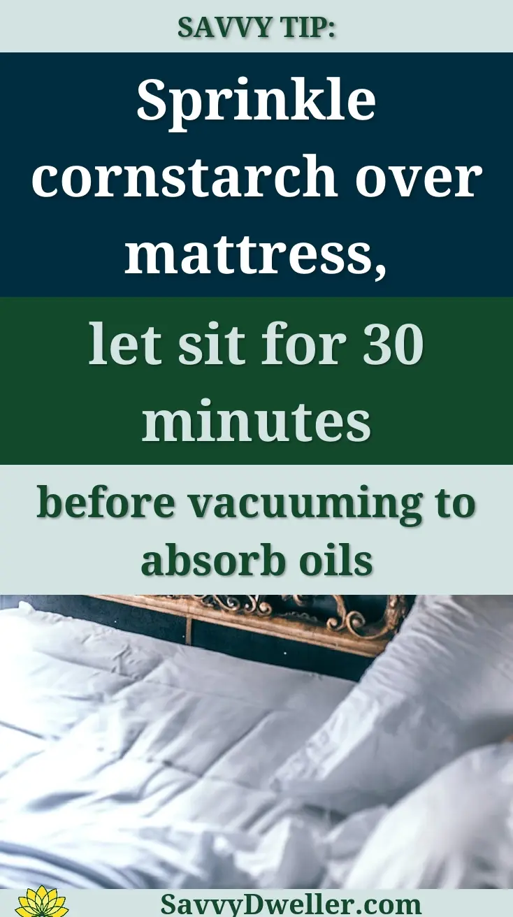 From above of comfortable unmade bed with white sheet and blanket and decorative carved elements on headboard