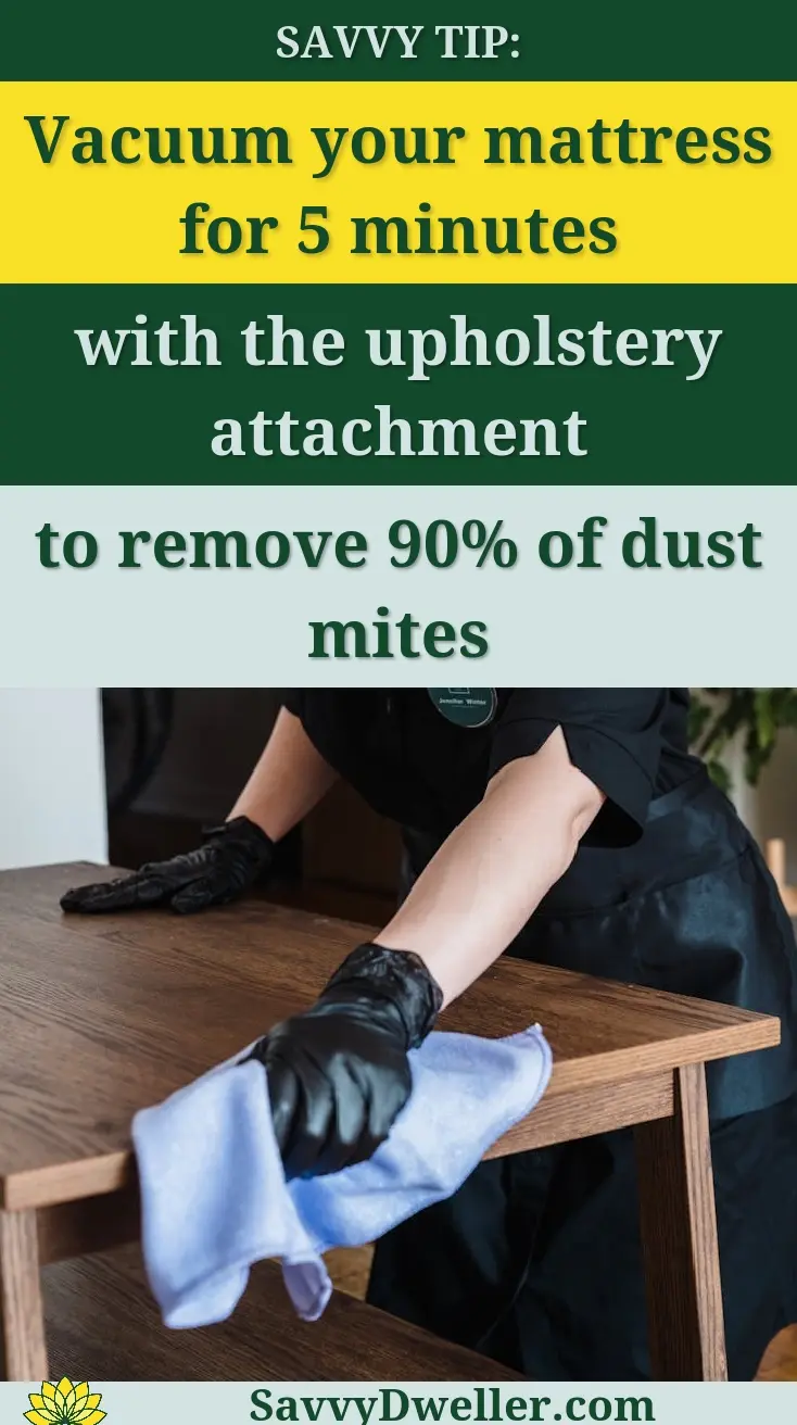 Vacuuming a mattress with upholstery attachment to reduce dust and allergens.