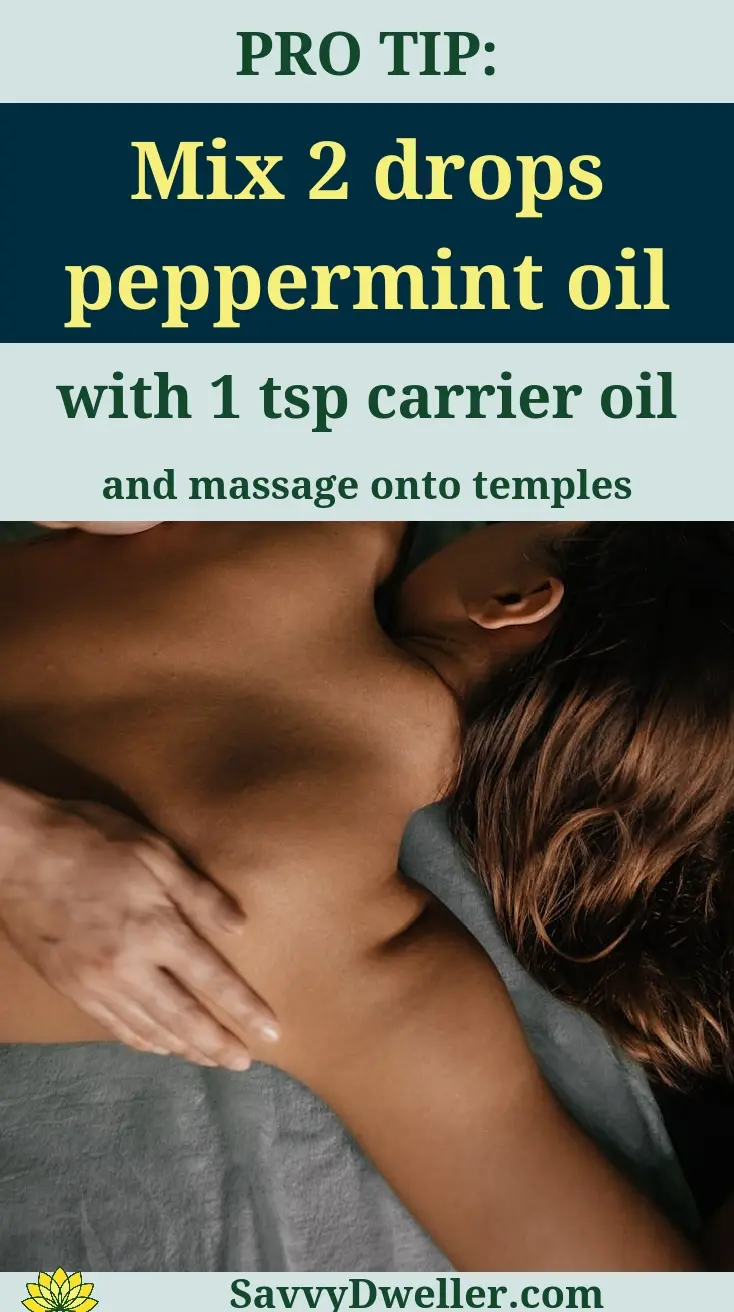 Person applying peppermint oil to temples for headache relief