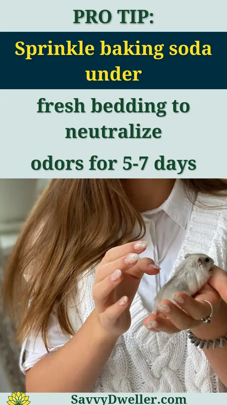 A young girl smiling indoors while gently holding her pet hamster, showing affection.