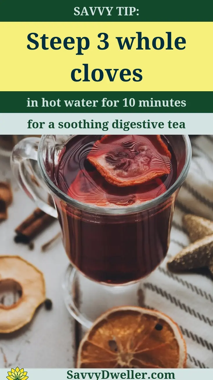 A cup of clove tea steeped with whole cloves for digestive health