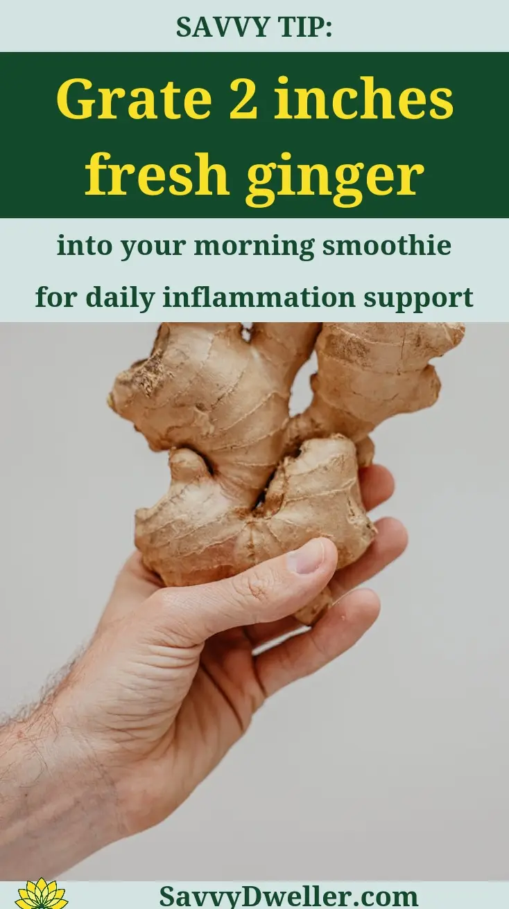 Hand holding fresh ginger root, showcasing its health benefits for inflammation support.