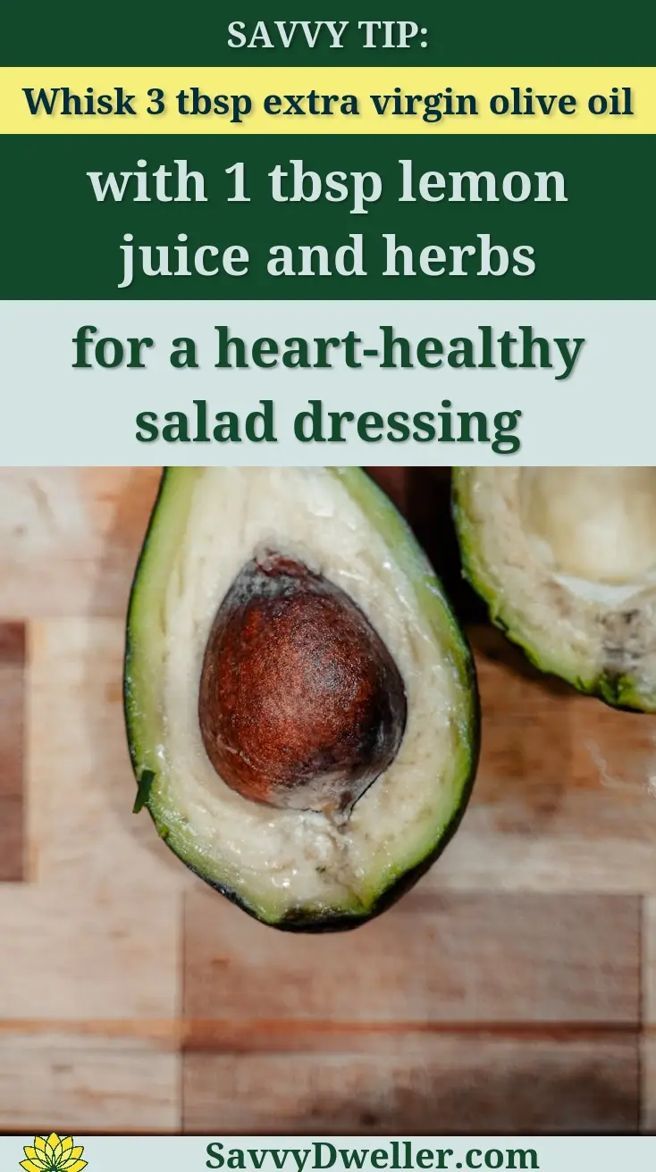 Fresh avocado sliced open on a wooden board, highlighting its seed and creamy texture.