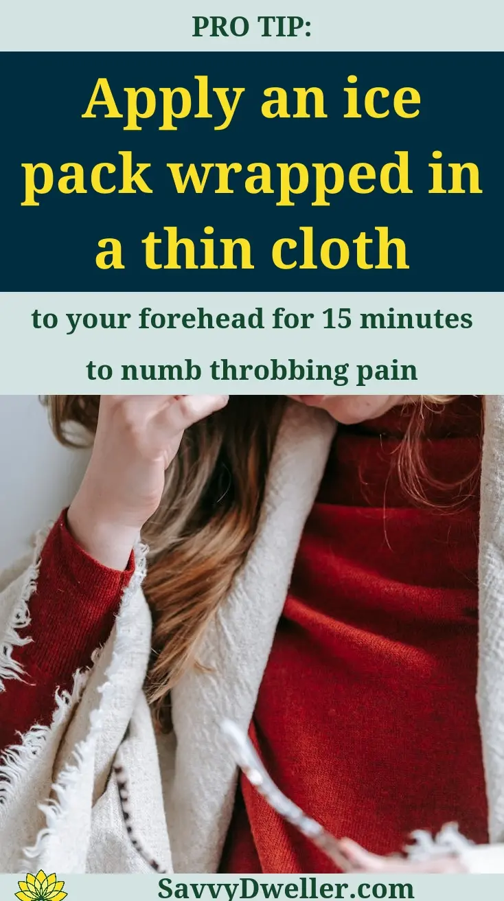 Woman applying an ice pack on her forehead to relieve migraine pain.
