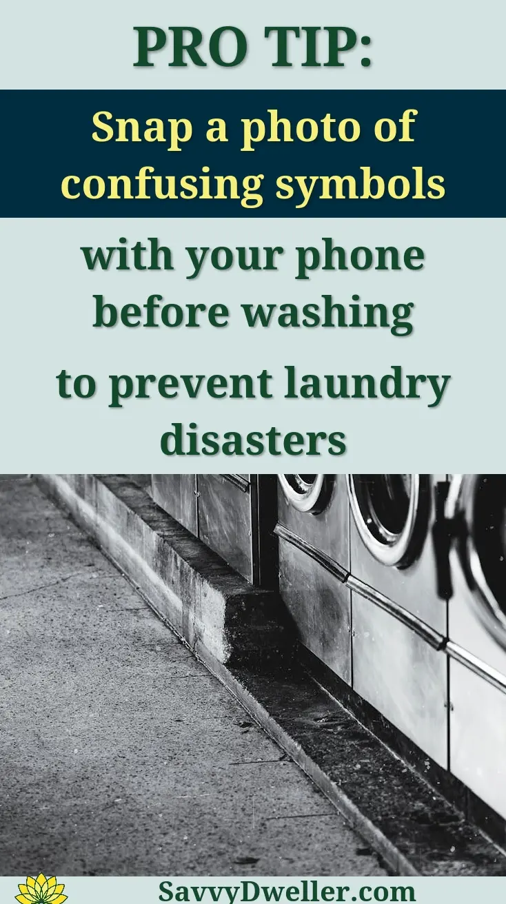 A row of industrial washing machines in an urban laundromat, showcasing steel finish.