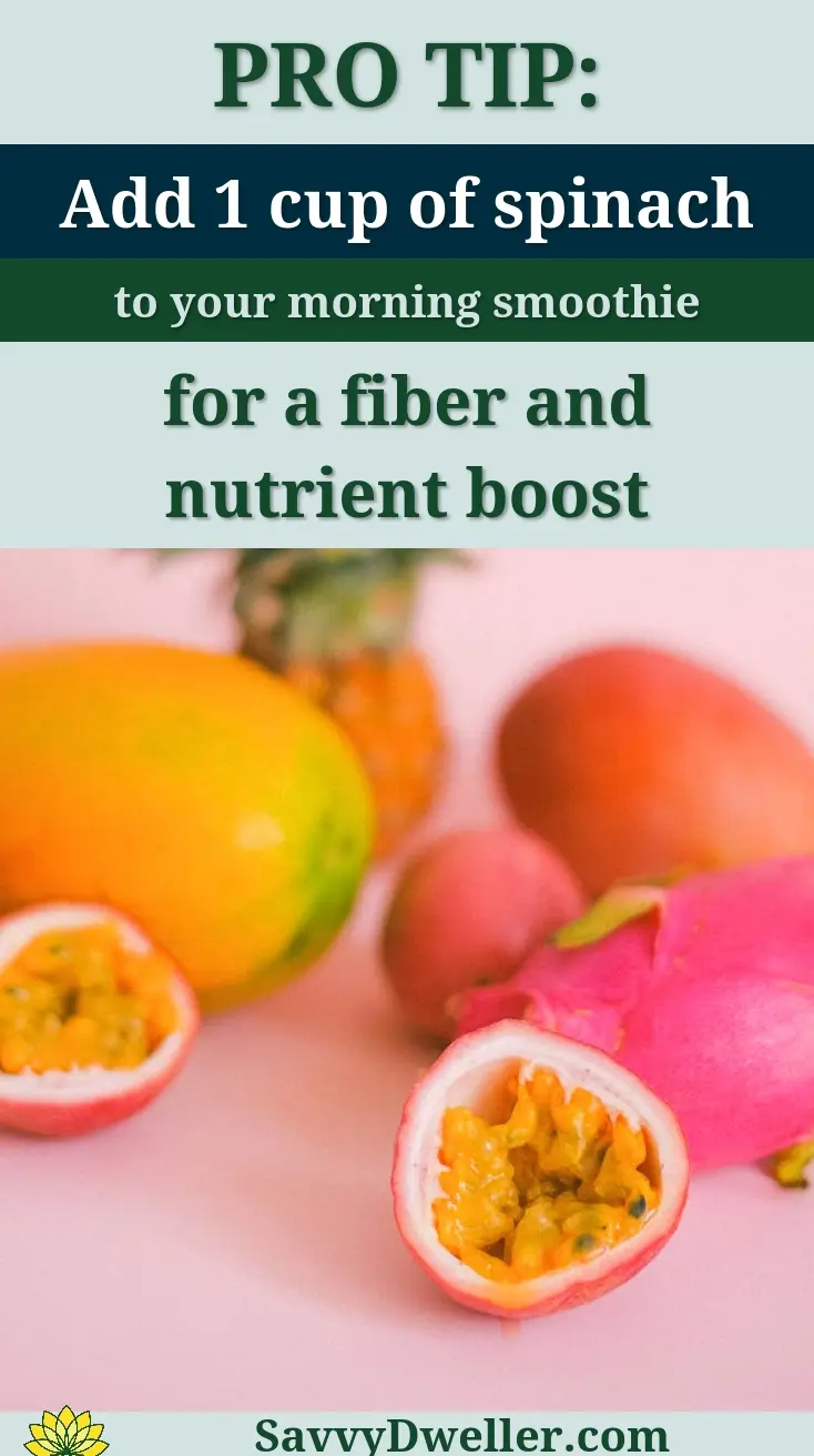 Colorful tropical fruits including pineapples, mangoes, and dragon fruit displayed on a pastel pink surface.