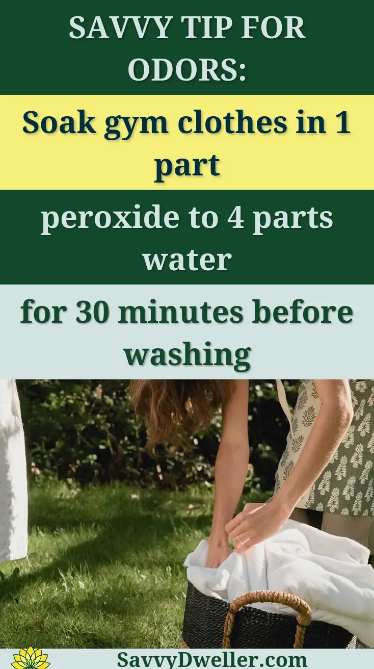 Young woman hanging laundry in garden, surrounded by greenery, on a sunny day.