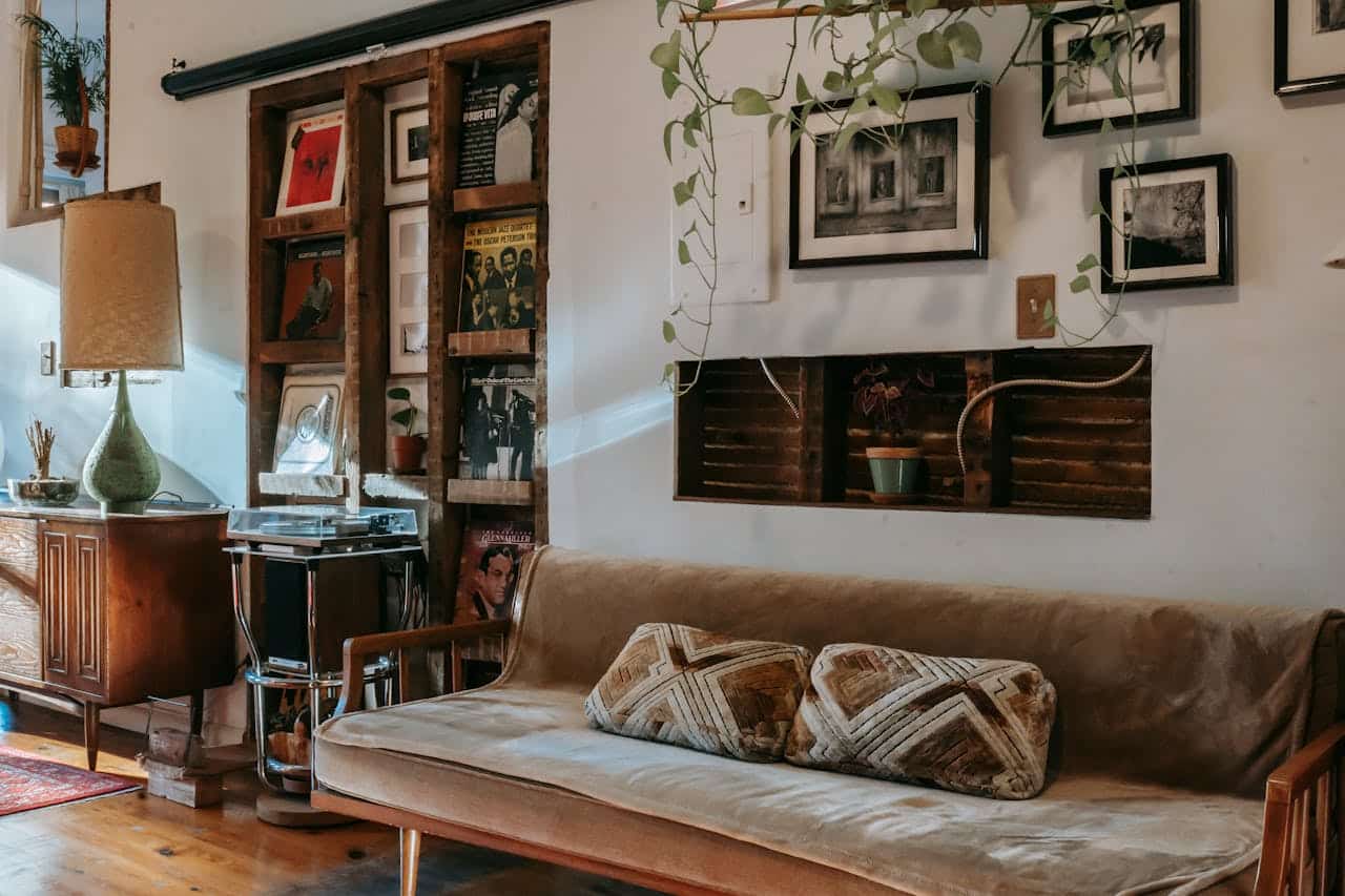 services-02 Interior of stylish living room with comfortable couch placed near shelf with collection of vintage vinyl records and wooden cabinet decorated with classic table lamp