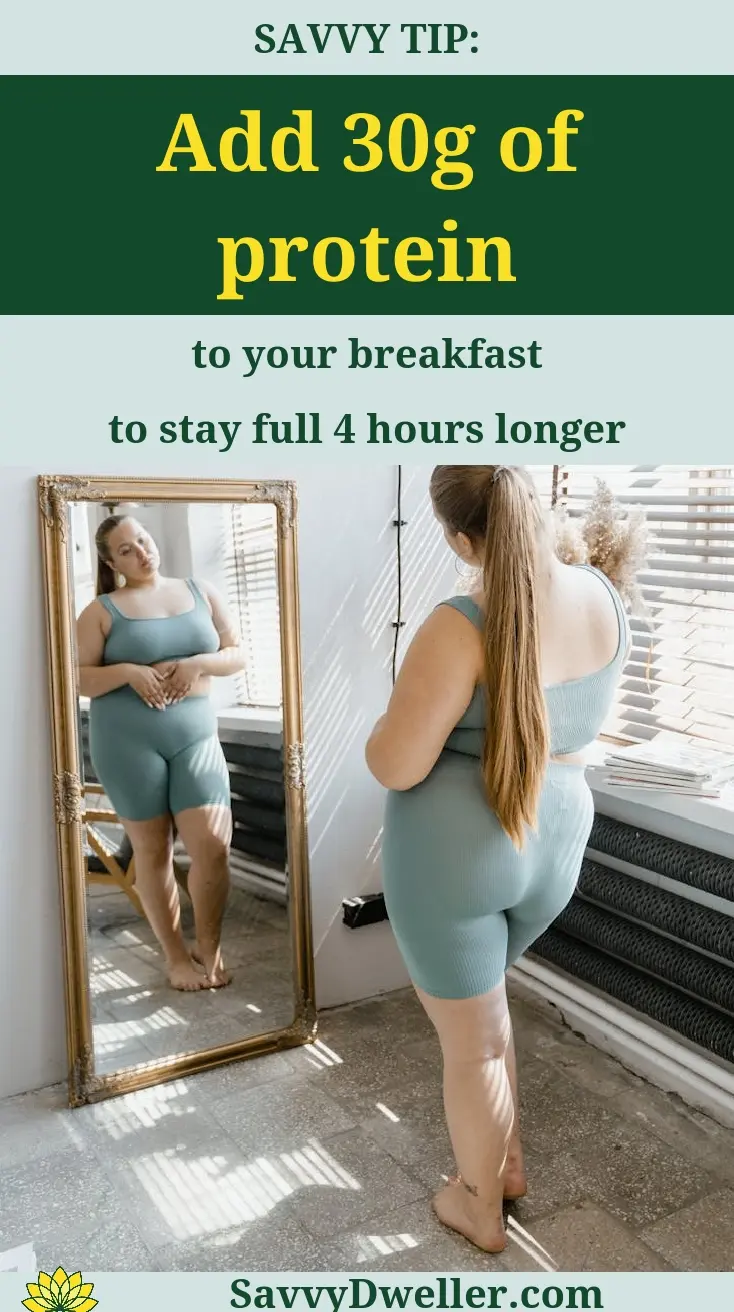 Woman in workout attire looking in a mirror, highlighting the importance of protein for weight loss.