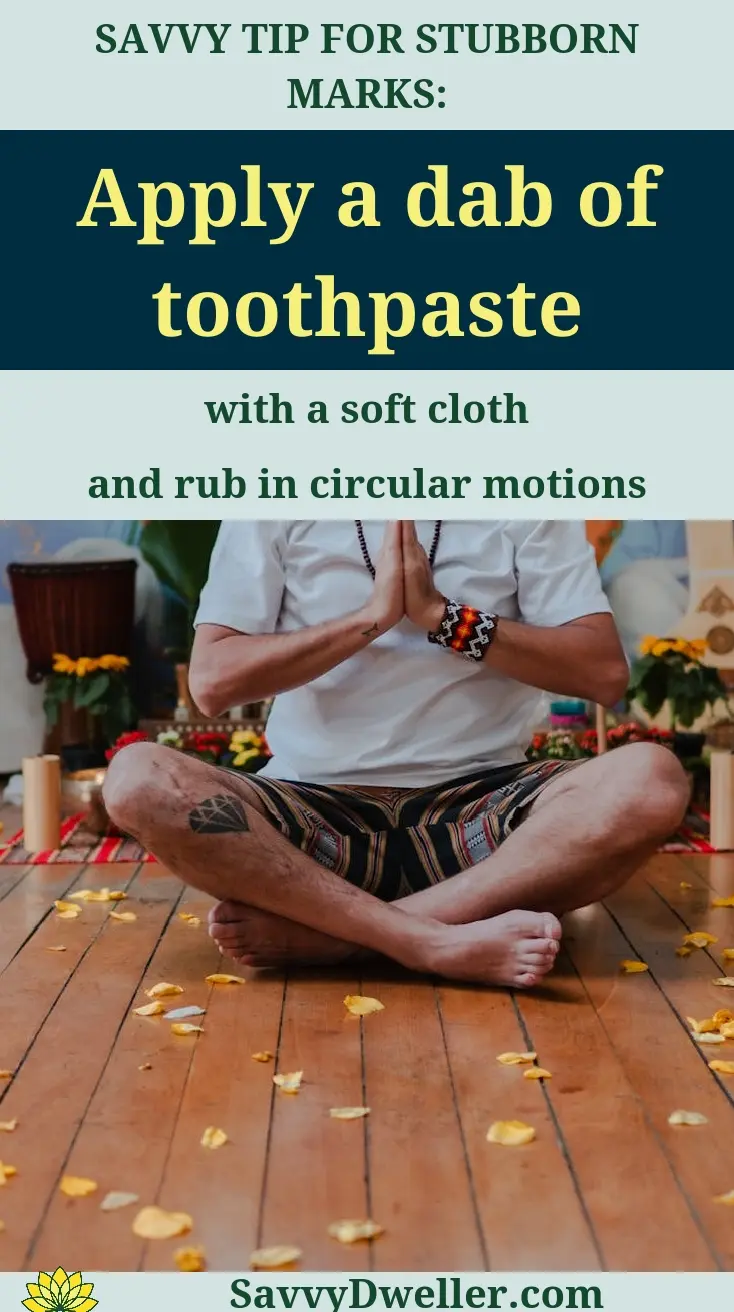 Person applying toothpaste on floor scuff marks to remove them