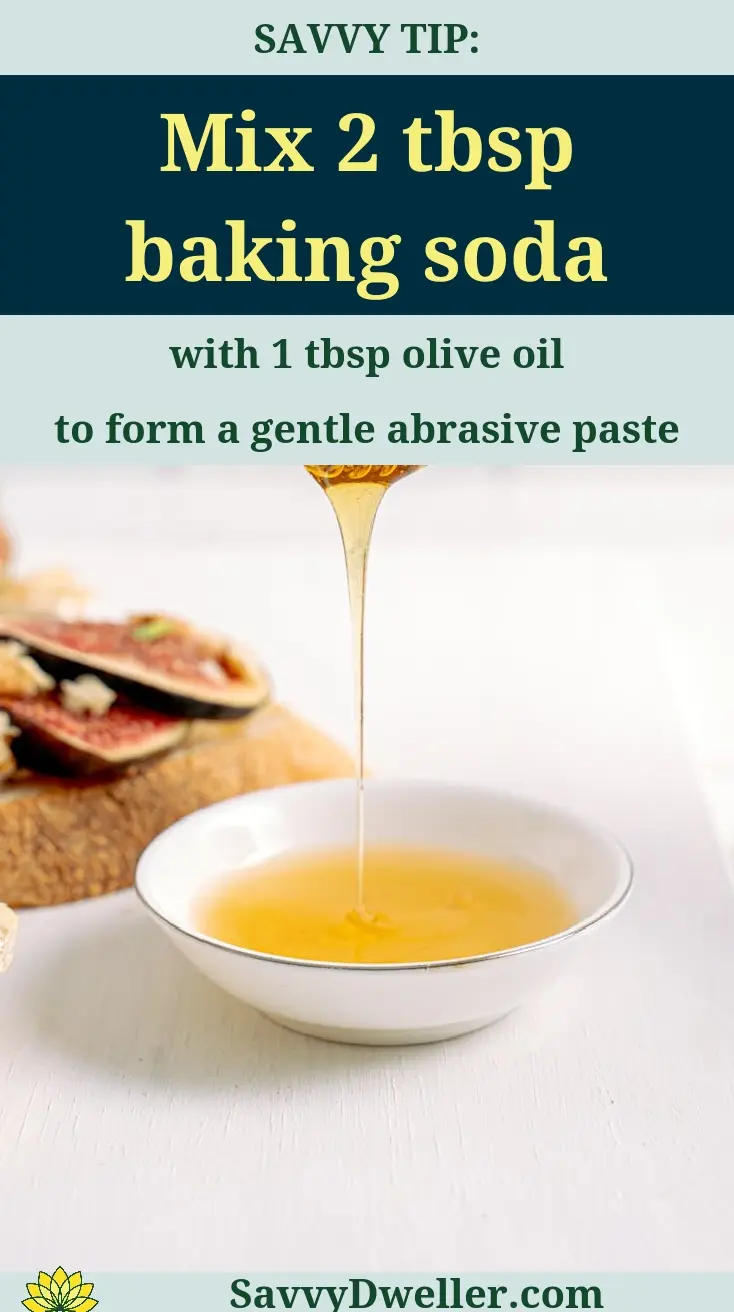 A mixture of baking soda and olive oil in a bowl for removing sticky residue from surfaces.