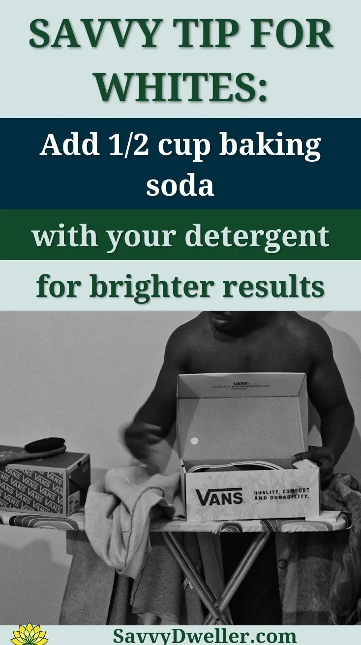 A man sorts clothes on an ironing board with a shoebox. Black and white.