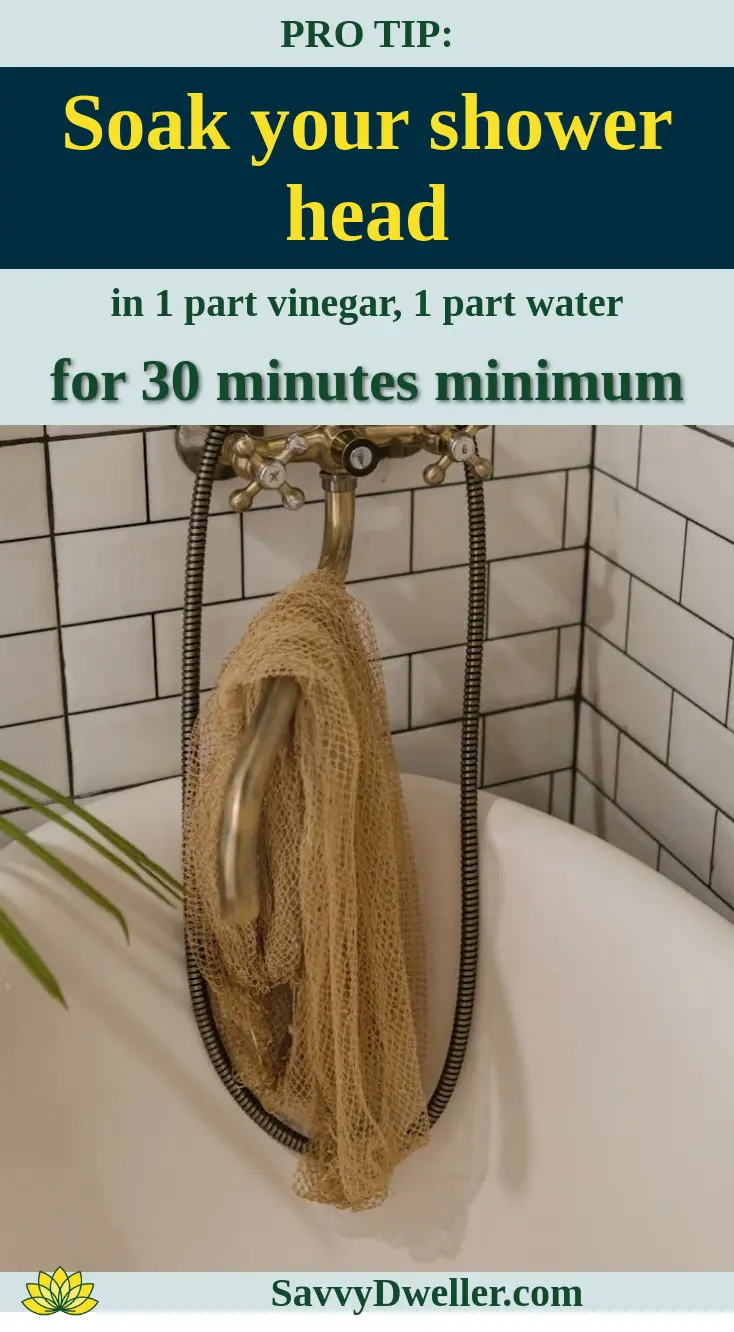A shower head soaking in vinegar and water mixture to improve water pressure by removing clogs.