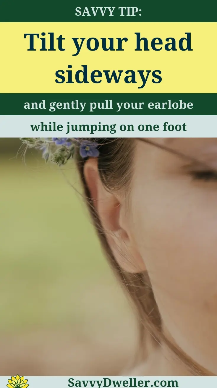 Tip on how to get water out of your ear by tilting your head and pulling your earlobe, related to swimmer's ear remedies.